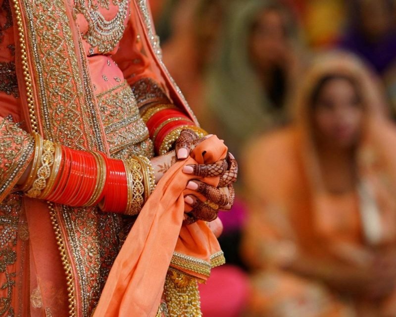 bride is wearing elaborate traditional attire
